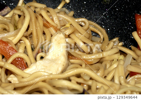 Close up of home made stir fry noodles being cooked 129349644