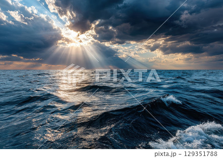 Vibrant ocean horizon with dynamic clouds and sun rays 129351788