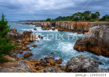 Rugged coastline with crashing waves and dramatic cliffs Rugged coastline with crashing waves and dramatic cliffs 129352014