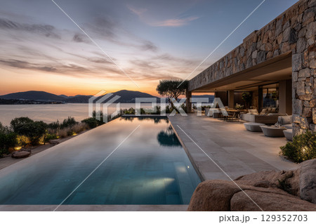 Luxury modern villa with infinity pool by the sea at sunset 129352703