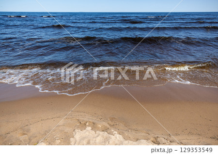 Coastal landscape with sandy ground and shore waves of Lake Ladoga 129353549