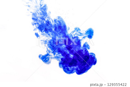 Blue ink injected into water from syringe, colour mixing with water creating abstract shapes 129355422