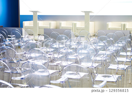 Transparent plastic chairs in conference room 129356815