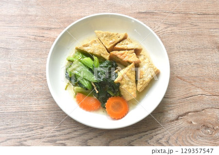 stir fried Chinese cabbage with needles mushroom and carrot topping tofu in soy sauce on plate stir fried Chinese cabbage with needles mushroom and carrot topping tofu in soy sauce on plate 129357547