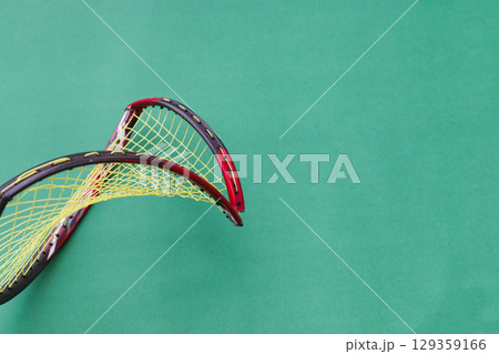 Broken Badminton Racket on Green Background 129359166