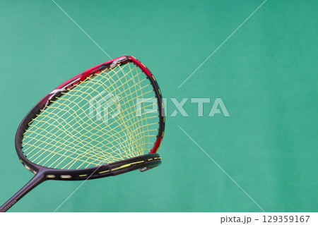Broken Badminton Racket on Green Background 129359167