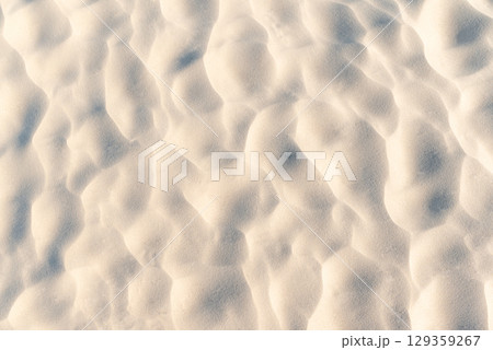 Sand on beach with wavy texture. Close up of sand on the beach with beautiful texture made by wind 129359267