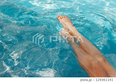 A girl's feet in a blue pool. Epilation of legs, varicose veins. Rest, relaxation on the beach, at the hotel. A woman in freedom. Vacation. High quality photo A girl's feet in a blue pool. Epilation of legs, varicose veins. Rest, relaxation on the beach, at the hotel. A woman in freedom. Vacation. High quality photo 129361141