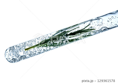 The texture of the serum with bubbles and rosemary in a test tube. The texture of the serum with bubbles and rosemary in a test tube. 129361578