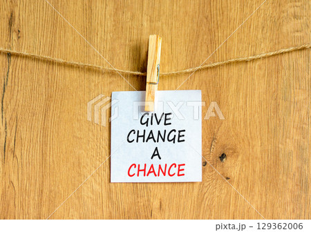 Give change a chance symbol. Concept words phrase Give change a chance on beautiful white paper on wooden clothespin. Beautiful wooden background. Business Give change a chance concept. Copy space. 129362006