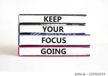 Keep your focus going symbol. Concept words Keep your focus going on beautiful books. Beautiful white table white background. Business and keep your focus going concept. Copy space. Keep your focus going symbol. Concept words Keep your focus going on beautiful books. Beautiful white table white background. Business and keep your focus going concept. Copy space. 129362034