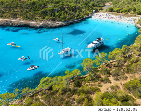 Aerial view. Yachts anchored in turquoise sea bay with pine trees 129362508