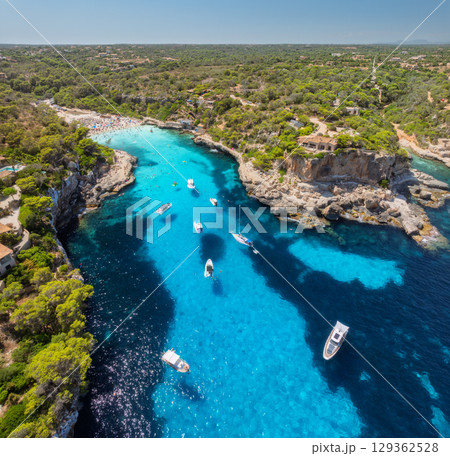 Aerial view of boats and yachts in crystal clear turquoise sea 129362528