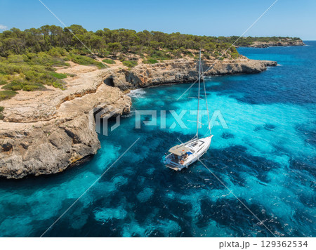 Aerial top view from drone of sailboat anchored in turquoise sea 129362534