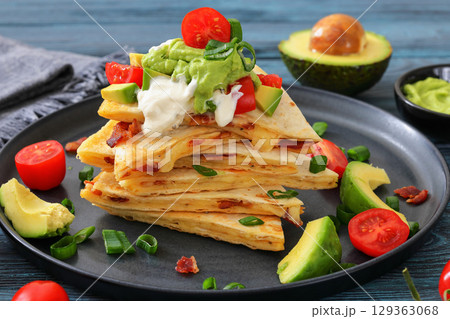 quesadilla with cheese, bacon, avocado on a plate 129363068