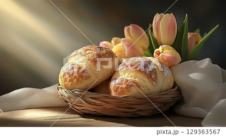 Fresh pastries and tulips in warm light create cozy atmosphere 129363567