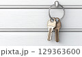 Two brass keys hanging on white wooden wall evoke curiosity 129363600