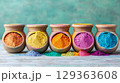 Vibrant colored powders in earthenware pots create joyful display 129363608