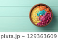 Vibrant colored powders in wooden bowl on teal wood 129363609