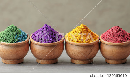 Vibrant colored powders in wooden bowls create stunning display 129363610