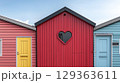 Vibrant colorful beach houses with heart shaped window create 129363611