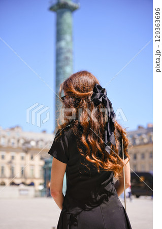 Woman with bow at Place Vendome Paris Woman with bow at Place Vendome Paris 129363696