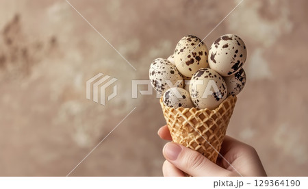 Quail Eggs In A Waffle Cone Held By Hand On A Beige Background At A Quail Farm 129364190