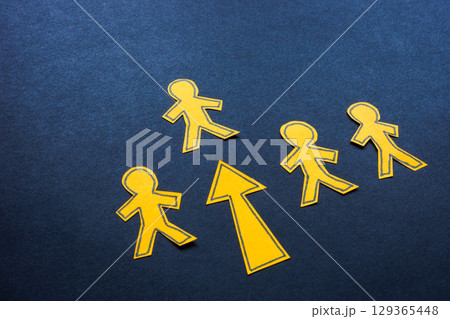 One figure in a row highlighted with an arrow. Leadership and selection. 129365448
