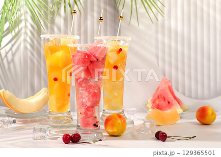 Refreshing summer homemade cocktail, sangria, lemonade with watermelon, melon, currant, mint, weight loss concept, healthy and natural nutrition, detox water with fruit flavor on light background 129365501