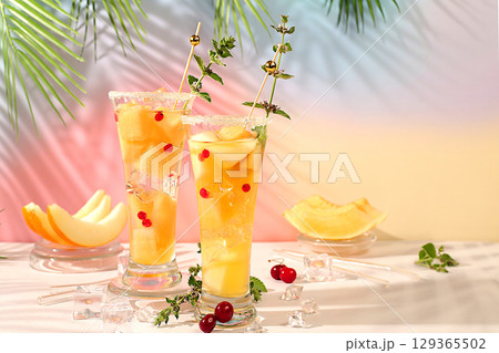 Refreshing summer homemade cocktail, sangria, lemonade with melon, currant, mint, weight loss concept, healthy and natural nutrition, detox water with fruit flavor on light background 129365502