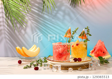 Mojito with melon, mint, watermelon, ice with tequila, vodka or soda water on elegant background, minimalist concept for bar, soft drink for weight loss, advertising banner for cafe 129365513
