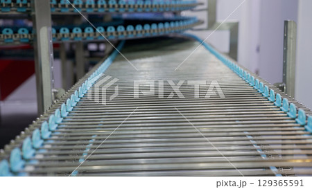 Empty industrial conveyor belt moving through automated production line 129365591