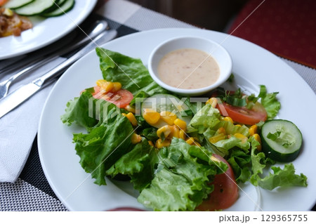 salad with fresh leaves and corn dip in sauce cucumbers tomatoes fresh tasty food diet salad with fresh leaves and corn dip in sauce cucumbers tomatoes fresh tasty food diet 129365755