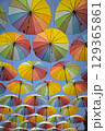 Many rainbow colored umbrellas against blue sky 129365861