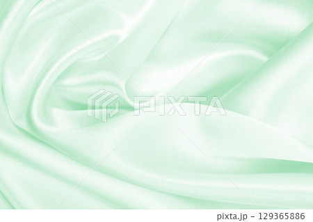 Smooth elegant green silk or satin luxury cloth texture as abstract background. Luxurious background design 129365886