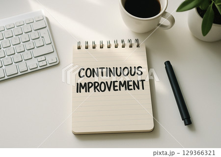 Top view of Continuous Improvement on white notepad representing Practices to Drive Innovation Across All Departments. 129366321