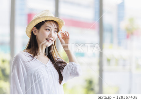 麦わら帽子をかぶって観光を楽しむ若い女性 麦わら帽子をかぶって観光を楽しむ若い女性 129367438