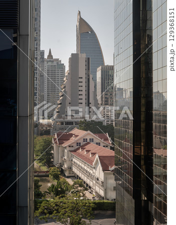 Beautiful historic building of Little Chapel (Wat Noi) inside Mater Dei School with the skyscraper in background. 129368151