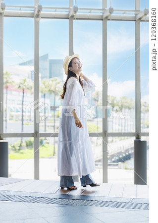 麦わら帽子をかぶって観光を楽しむ若い女性 129368160