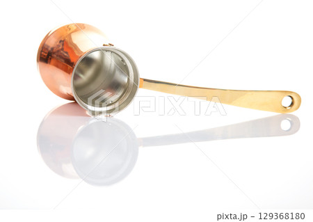 A classic Turkish coffee pot made of copper with a sleek brass handle A classic Turkish coffee pot made of copper with a sleek brass handle 129368180