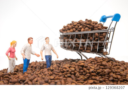 Unique image of tiny figures standing on coffee beans, a cart brimming with beans Unique image of tiny figures standing on coffee beans, a cart brimming with beans 129368207