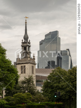the historic church of St Augustine Watling Street church with a modern angular skyscraper known as the Cheesegrater. 129368450
