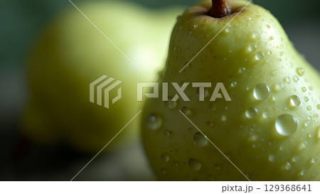 Close up of fresh green pears with water droplets glistening on their surface enhancing visual appeal 129368641