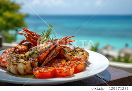 plate of fresh, grilled seafood with prawns and lobster on the beach in sunny Caribbean island 129371281