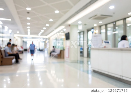 Blurry Hospital Interior with Reception Area and Patients in Waiting Room Environment 129371755