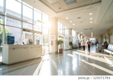 Bright and Open Hospital Corridor with People Walking in Calm Environment 129371764