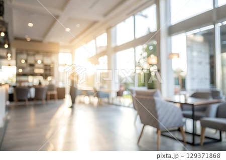 Soft Focus Interior of Modern Cafe with Natural Light Streaming Through Windows 129371868