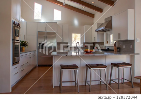 Modern Bright Kitchen with Open Layout and Natural Light Streaming Through Windows Modern Bright Kitchen with Open Layout and Natural Light Streaming Through Windows 129372044