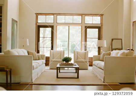 Cozy Contemporary Living Room with Natural Light and Elegant White Sofas and Decor 129372059