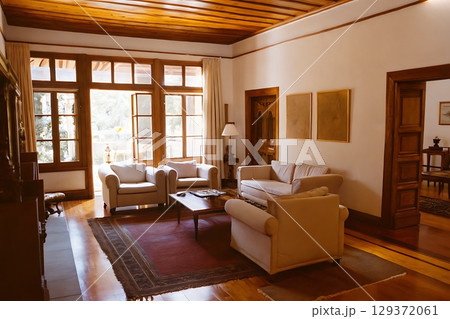 Elegant and Cozy Living Room with Natural Light and Wooden Accents in a Relaxing Environment 129372061